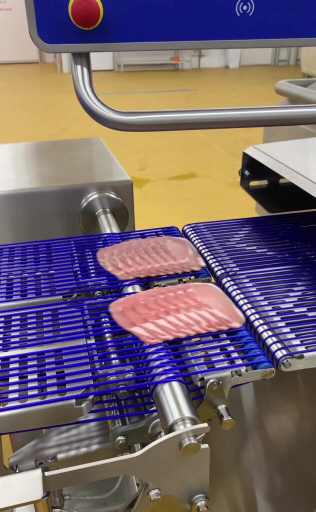 Sliced bacon on conveyor belt